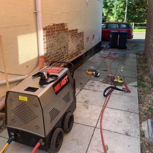 Red Mist steam pressure cleaner removing masonry paint